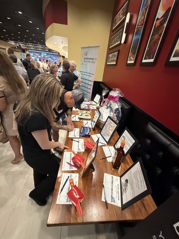 Guests browsing the silent-auction table.